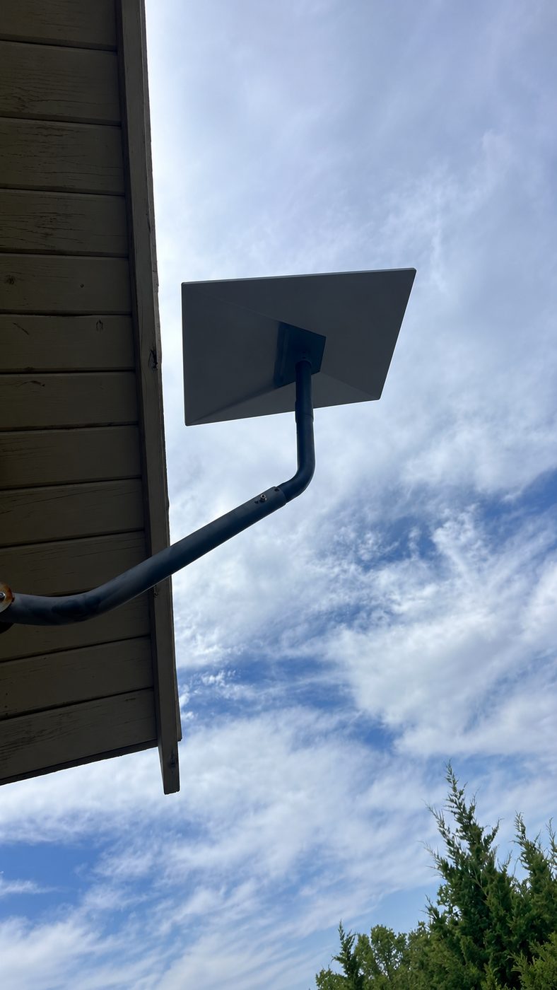 Eave mount holding the dish clear of the roofline on a place near Pottsboro