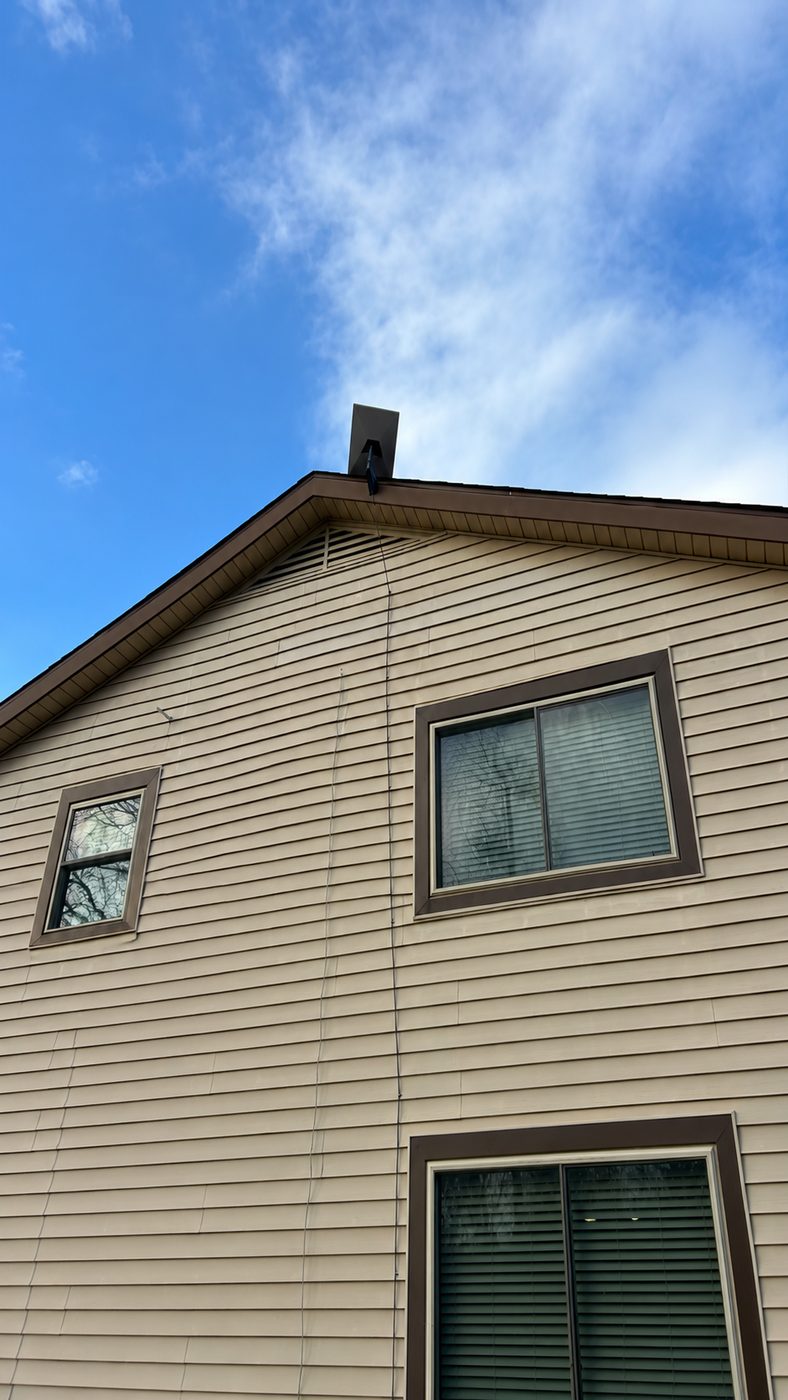 Gable-end mount with the cable run dressed down the siding, Denison