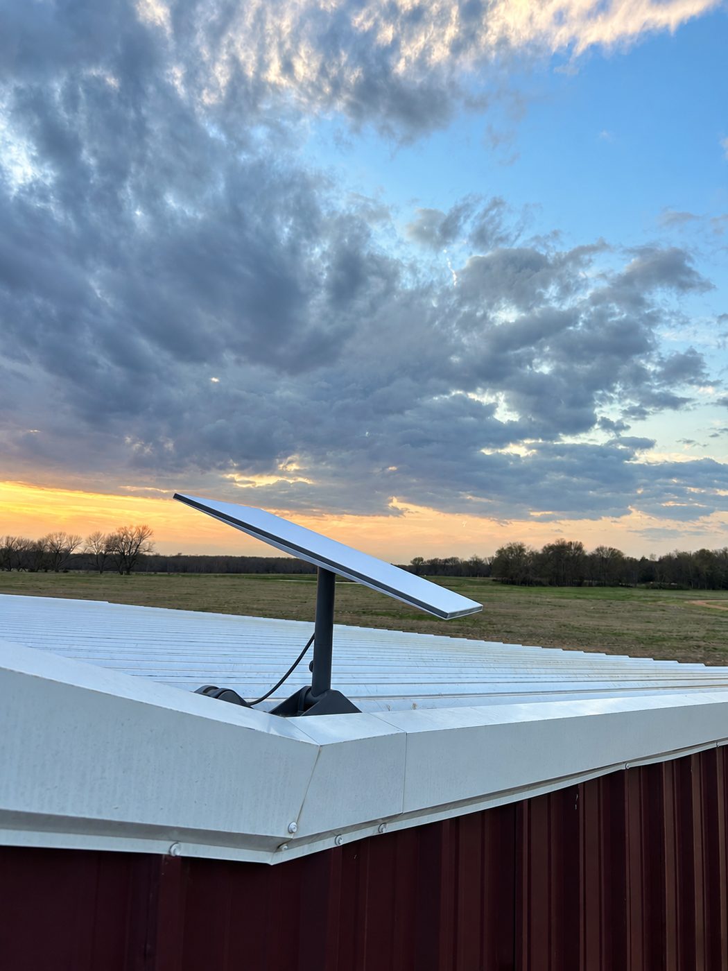 Evening install on a shop roof outside Denison, open pasture and a clear northern horizon