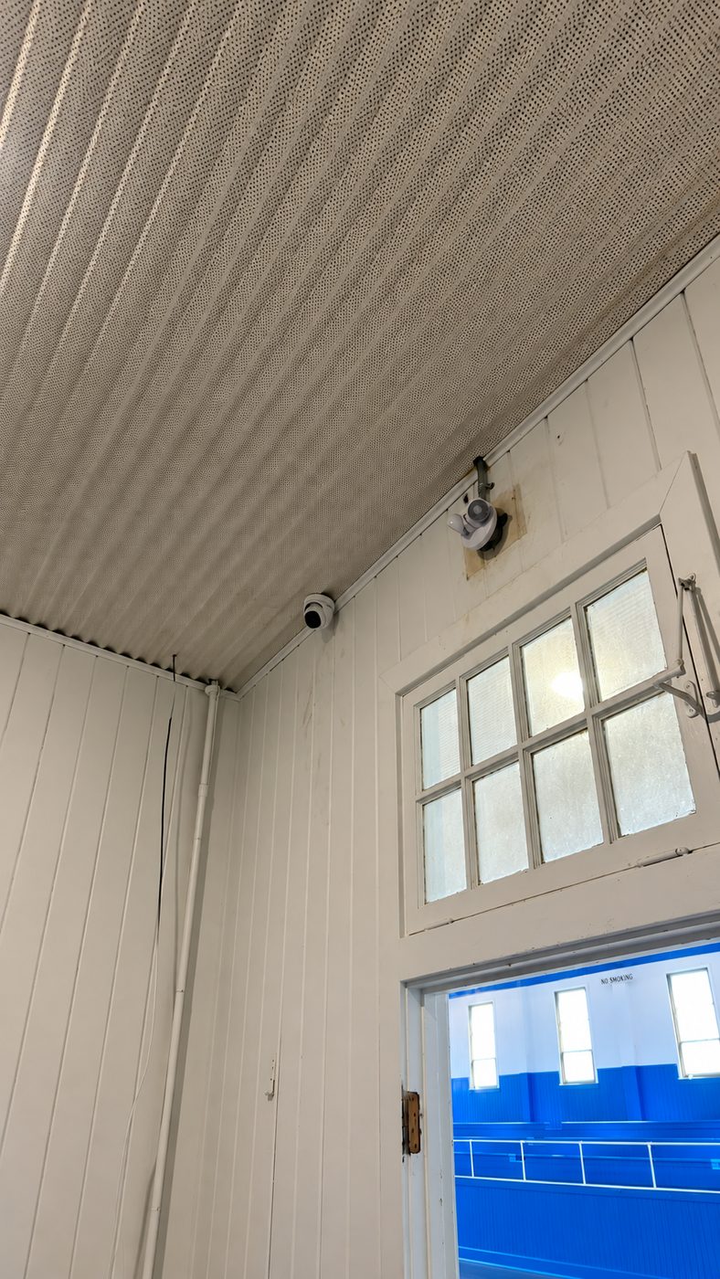 Dome camera and surface conduit inside a shop building near Denison